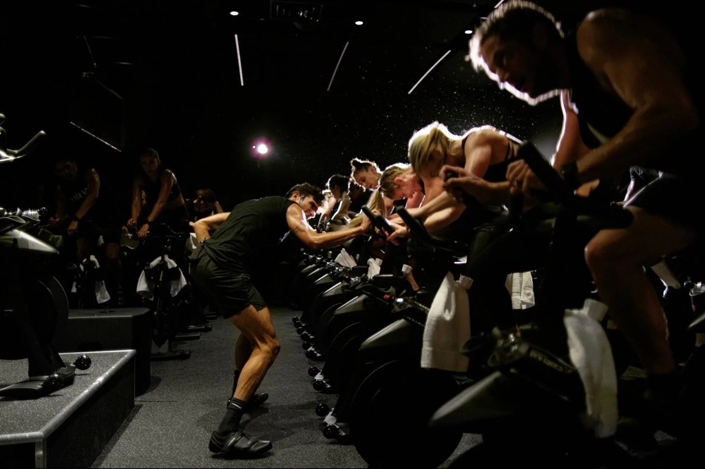 A spin class in a dark studio